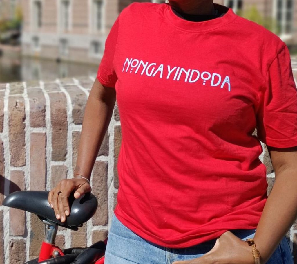 A red shirt printed with the word "nongayindoda" — an example of wearable theory