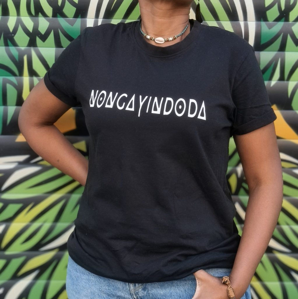 A black shirt printed with the word "nongayindoda" — an example of wearable theory