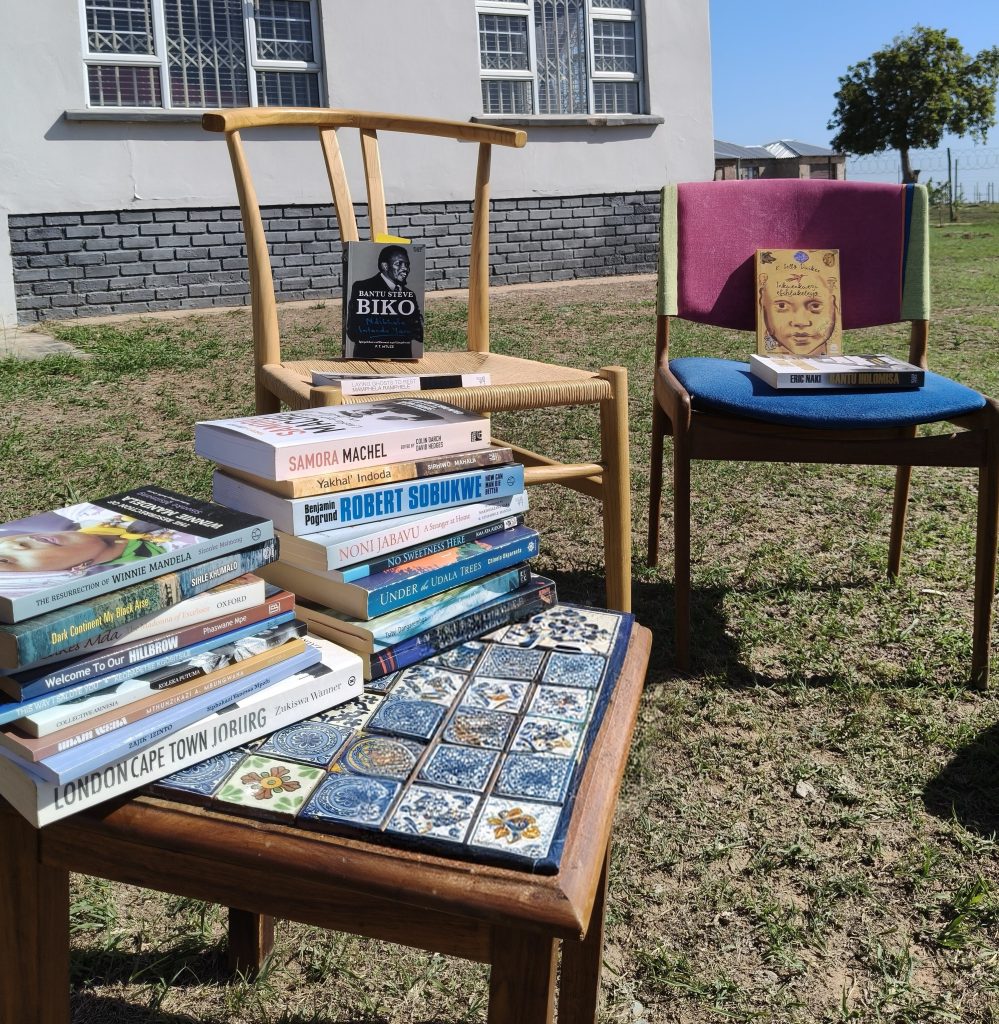 Books and chairs arranged outdoors for the Funda Nathi community reading circle