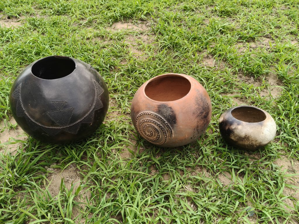 Three clay pots on the ground